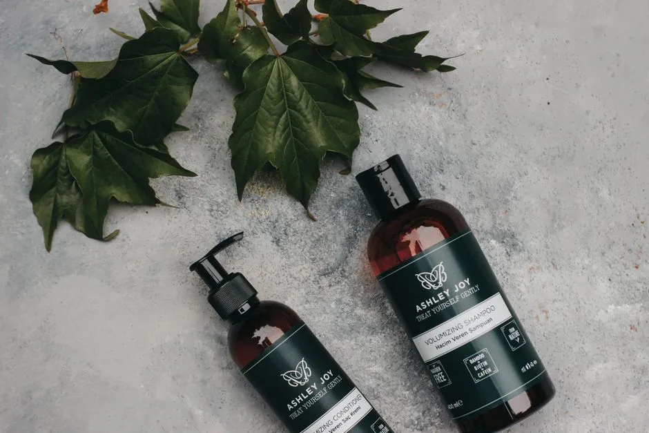 Natural volumizing shampoo and conditioner with green leaves for organic hair care.